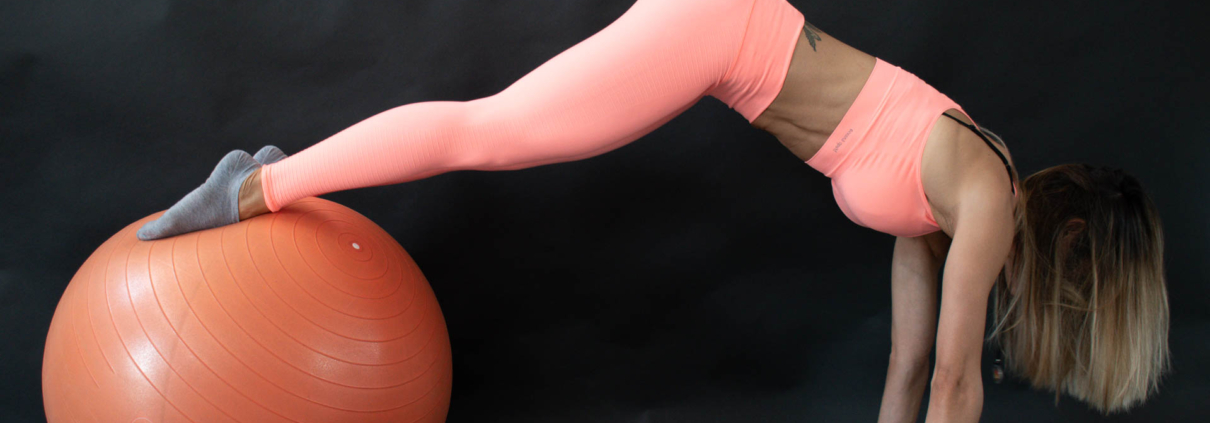 Danila Mancinelli esegue esercizio di fitness con fitball arancione